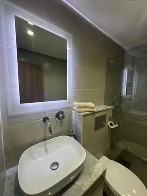 a bathroom with a white sink and a shower at Duplex spacieux avec jaccuzi in Marrakech