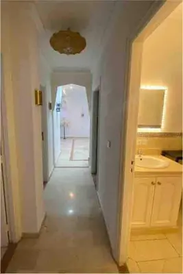 a hallway leading to a kitchen with a sink at Gueliz ultra central & Cosy in Marrakech