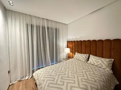 a bedroom with a large bed with a large window at NEW LUXURY APARTMENT - ViCTOR HUGO MARRAKECH in Marrakech