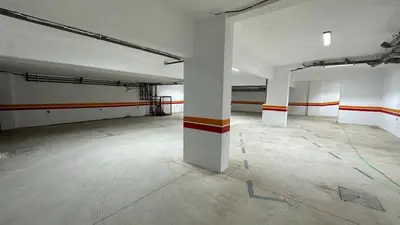 an empty room with white walls and orange and white columns at NEW LUXURY APARTMENT - ViCTOR HUGO MARRAKECH in Marrakech
