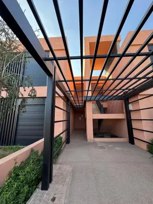 a pergola over a walkway in a building at Rez de Jardin T3 Piscine Noria in Marrakech