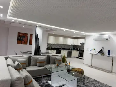a living room with a couch and a table at Duplex 3 chambres centre ville in Marrakech