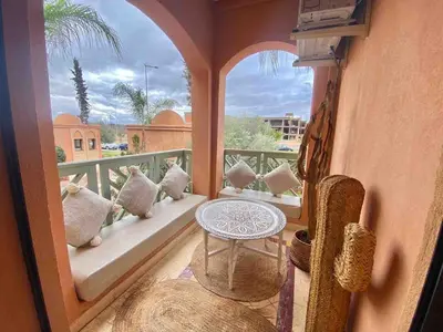 a balcony with a table on a balcony at Peaceful heaven in Marrakech