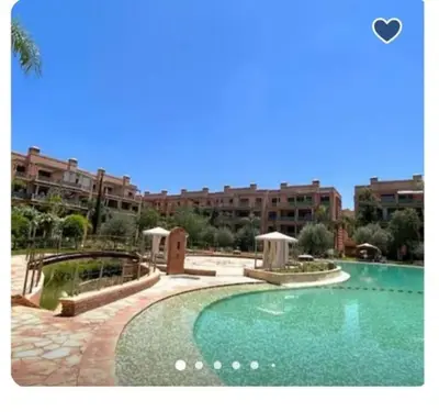 a large swimming pool in front of a building at Peaceful heaven in Marrakech