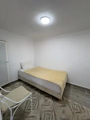 a room with a bed and a chair in it at Daryussef 114 in Marrakech