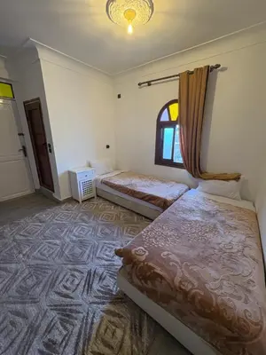 a bedroom with two beds and a window at Daryussef 114 in Marrakech