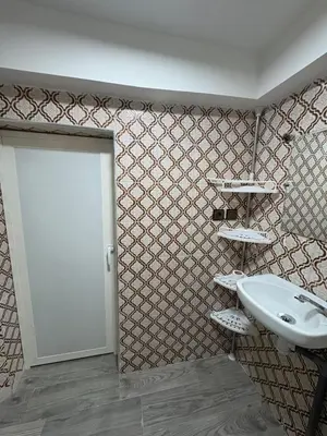 a bathroom with a white sink and a door at Daryussef 114 in Marrakech