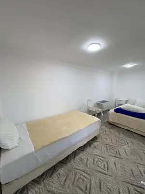 a bedroom with two beds and a table in it at Daryussef 114 in Marrakech