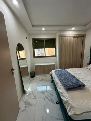a bedroom with a bed and a mirror on the floor at chiimappart in Marrakech