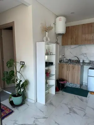 a kitchen with a white refrigerator in a room at chiimappart in Marrakech