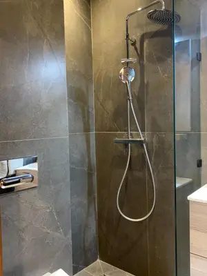 a bathroom with a shower with a glass door at Appartement Mazal in Marrakech