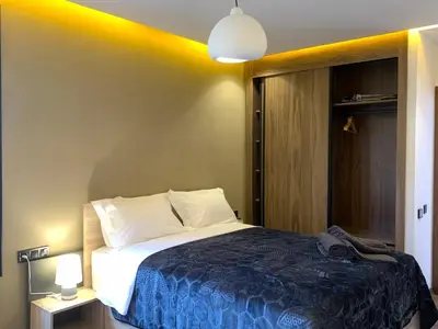a bedroom with a large bed with a blue blanket at Appartement Mazal in Marrakech