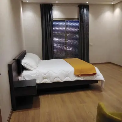a bedroom with a large bed and a window at Akenza hospitality in Marrakech