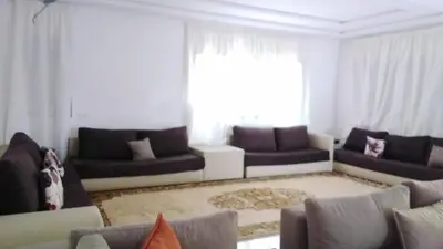 a living room with couches and a large window at Akenza hospitality in Marrakech