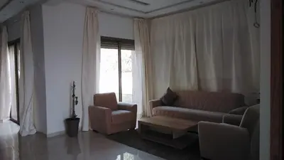 a living room with a couch and a chair at Akenza hospitality in Marrakech