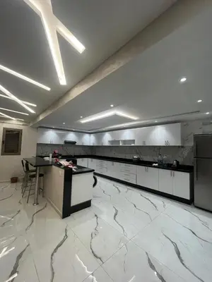 a large kitchen with a large white marble floor at Akenza hospitality in Marrakech