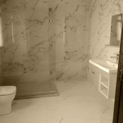 a bathroom with a shower and a toilet and a sink at Akenza hospitality in Marrakech
