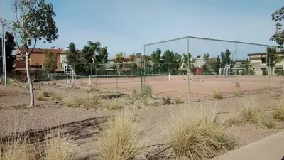 an empty tennis court with a tennis court at Akenza hospitality in Marrakech