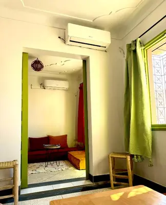 a living room with a couch and a window at Maison au cœur de Marrakech in Marrakech