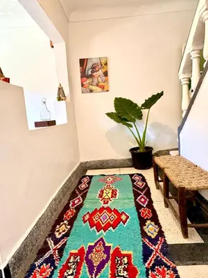 a rug on the floor in a hallway with a stairway at Maison au cœur de Marrakech in Marrakech
