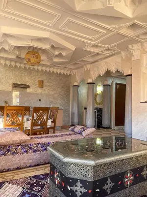a large room with two beds and a table at Moroccan culture Apt! Airport in Marrakech