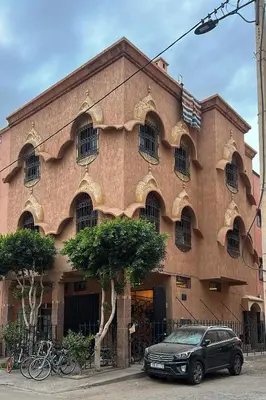 a black car parked in front of a building at Moroccan culture Apt! Airport in Marrakech