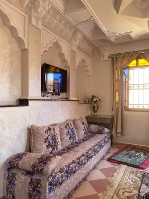 a living room with a couch and a tv at Moroccan culture Apt! Airport in Marrakech