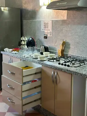 a kitchen with a stove and a counter top at Moroccan culture Apt! Airport in Marrakech