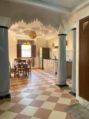 a kitchen and dining room with a table and chairs at Moroccan culture Apt! Airport in Marrakech