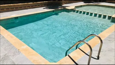 a large swimming pool with a hand rail in it at chic nest heart of gueliz With pool in Marrakech