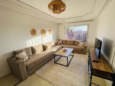 a living room with a couch and a tv at chic nest heart of gueliz With pool in Marrakech