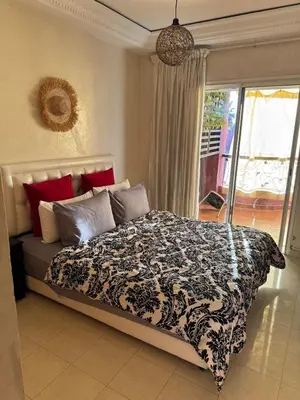 a bedroom with a bed with a black and white comforter at chic nest heart of gueliz With pool in Marrakech