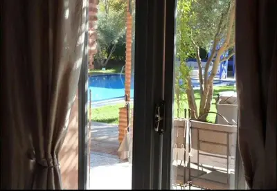 an open door with a view of a pool at Luxury villa - AC- 5BR-11P- Palmeraie Marrakech in Marrakech