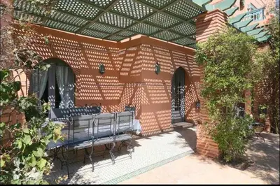 a brick building with a bench in a courtyard at Luxury villa - AC- 5BR-11P- Palmeraie Marrakech in Marrakech