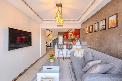 a living room with a couch and a table at Magnifique Duplex avec piscine privée in Marrakech