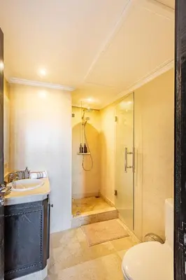 a bathroom with a shower and a sink and a toilet at Magnifique Duplex avec piscine privée in Marrakech
