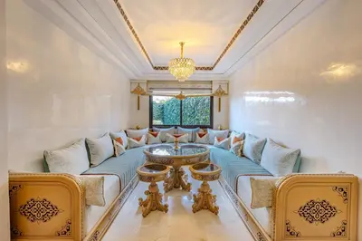 a living room with a blue couch and a table at Magnifique Duplex avec piscine privée in Marrakech