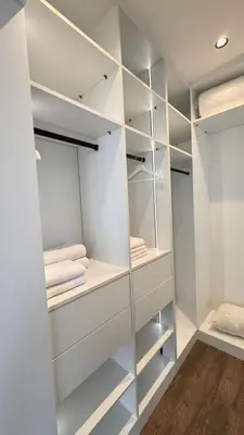a walk in closet with white walls and shelves at villa Argan, Confort & Modern avec PiscineChauffée in Marrakech