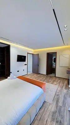 a large bedroom with a large bed and a television at villa Argan, Confort & Modern avec PiscineChauffée in Marrakech
