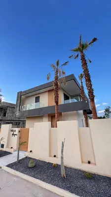 a building with palm trees in front of it at villa Argan, Confort & Modern avec PiscineChauffée in Marrakech