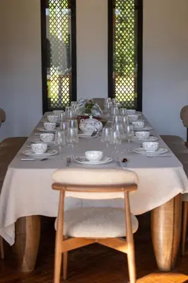 a long table with glasses and plates on it at Villa Yliane in Marrakech