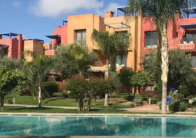 a resort with a swimming pool in front of a building at Luxueuse Appart Vizir 106 in Marrakech