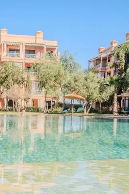 a large pool of water in front of a building at Luxury 2BR with Pool & Garden View Balcony in Marrakech