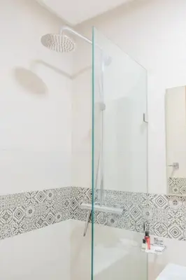 a shower with a glass door in a bathroom at Luxury 2BR with Pool & Garden View Balcony in Marrakech