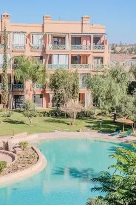 a large apartment building with a large swimming pool at Luxury 2BR with Pool & Garden View Balcony in Marrakech