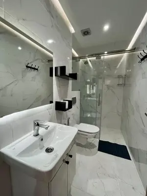 a white bathroom with a sink and a shower at Modern Stay 3 bedroom City Center with Balcony in Marrakech