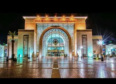a large building with an arch in a city at night at apartment 12 Marrakech centr gueliz in Marrakech