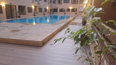 a large swimming pool in a building with aestone sidx sidx sidx at apartment 12 Marrakech centr gueliz in Marrakech