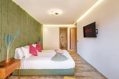 a bedroom with a white bed with pink pillows at Large elegant 2BR Apt in Gueliz in Marrakech