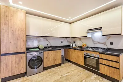 a kitchen with wooden cabinets and a dishwasher at Large elegant 2BR Apt in Gueliz in Marrakech
